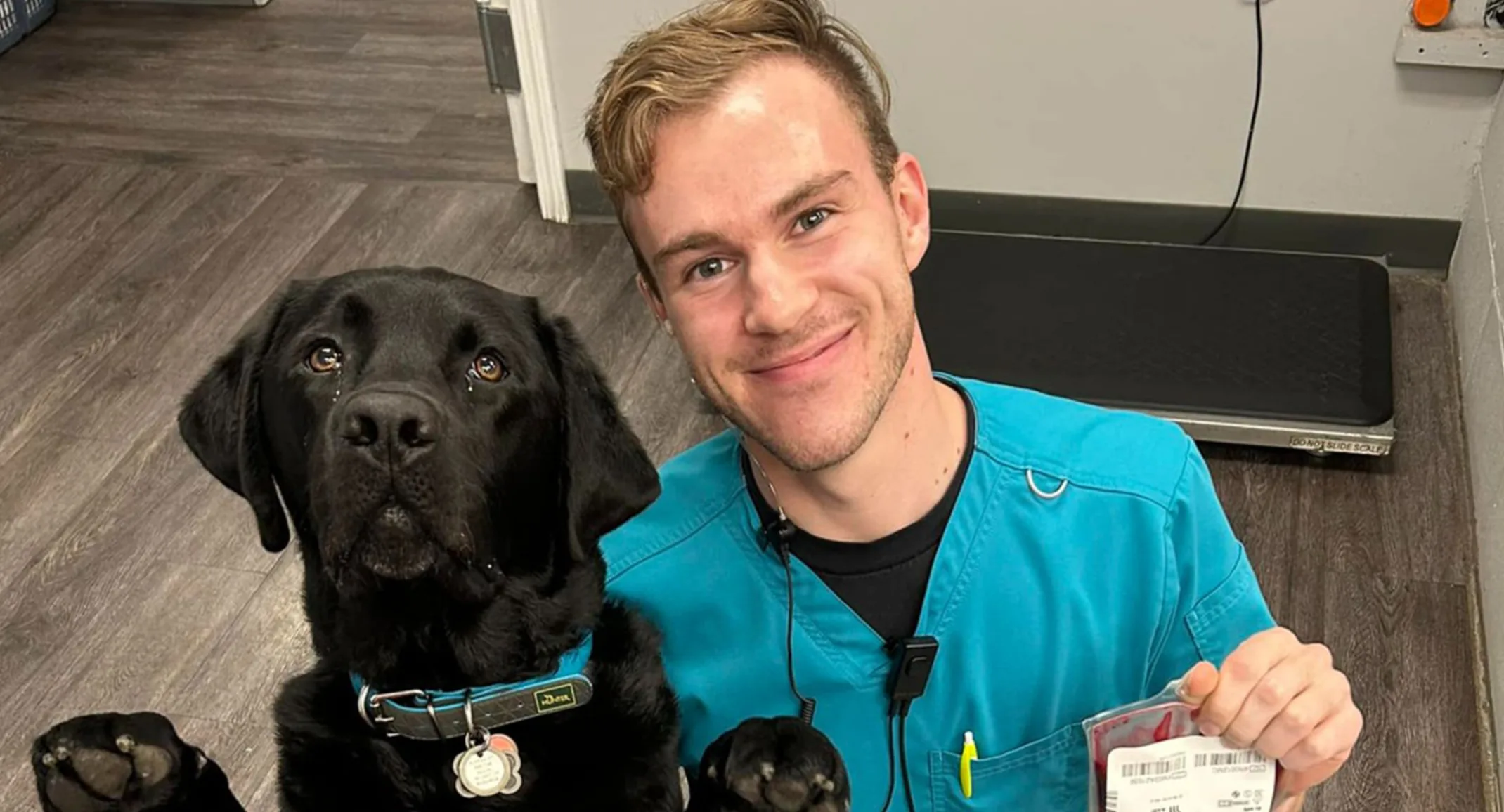 A photo of a veterinary student with a black lab
